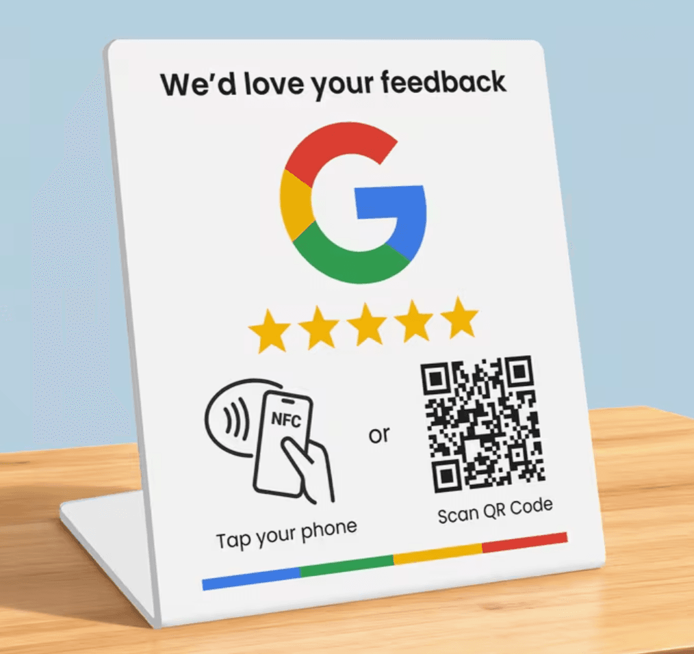 White NFC table stand asking customers to tap their phone or scan a QR code to review the business on Google